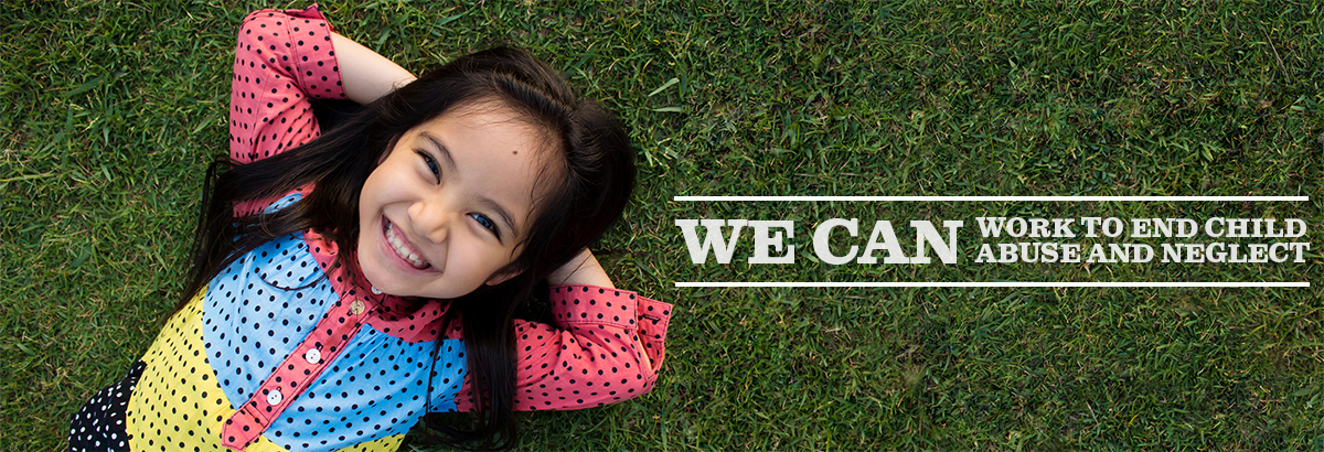 little girl smiling laying on the grass